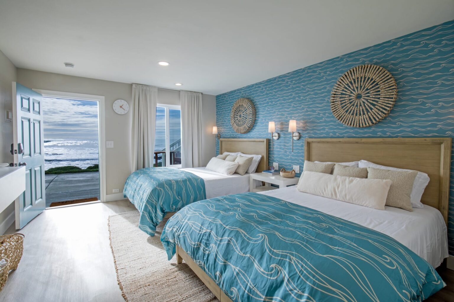 A Bedroom with Two Separate Beds Against Calming Blue Walls in Shelter Cove, CA