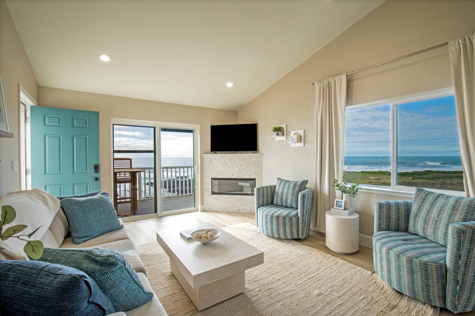A Living Room with Large Windows Showing a View of the Ocean in Shelter Cove, CA