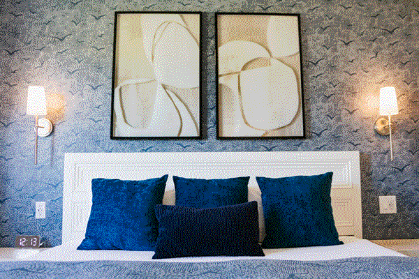 Stylish bed with vibrant blue pillows, perfect for relaxation in Redwood