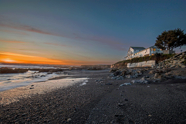 Beach house at sunset with warm colors lighting up the view in Redwood